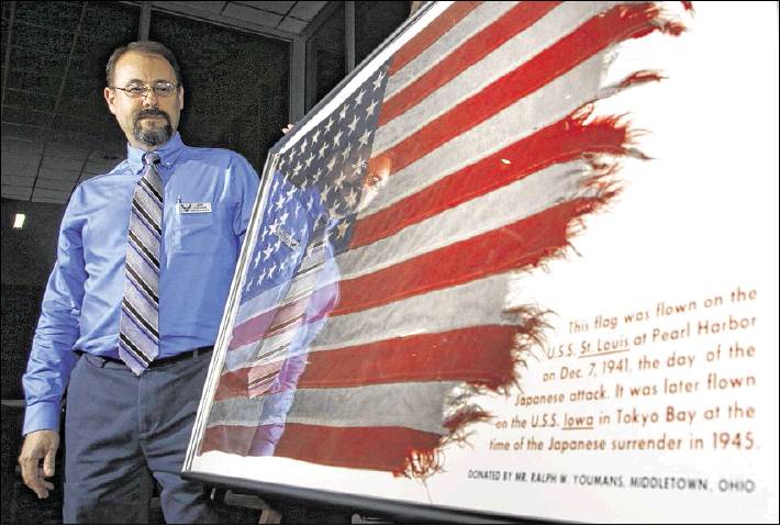 From Dayton Daily News: Jeff Duford, curator for the National Museum of the U.S. Air Force, with a flag that flew on the U.S.S. St. Louis in Hawaii during the attack on Pearl Harbor on Dec. 7, 1941. The same flag flew aboard the U.S.S. Iowa in Tokyo Bay on September 16, 1944, as Japan signed instruments of surrender aboard the U.S.S. Missouri. 